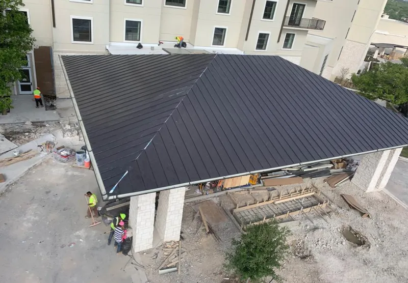 Metal roofing installation team working on a commercial building in Athens